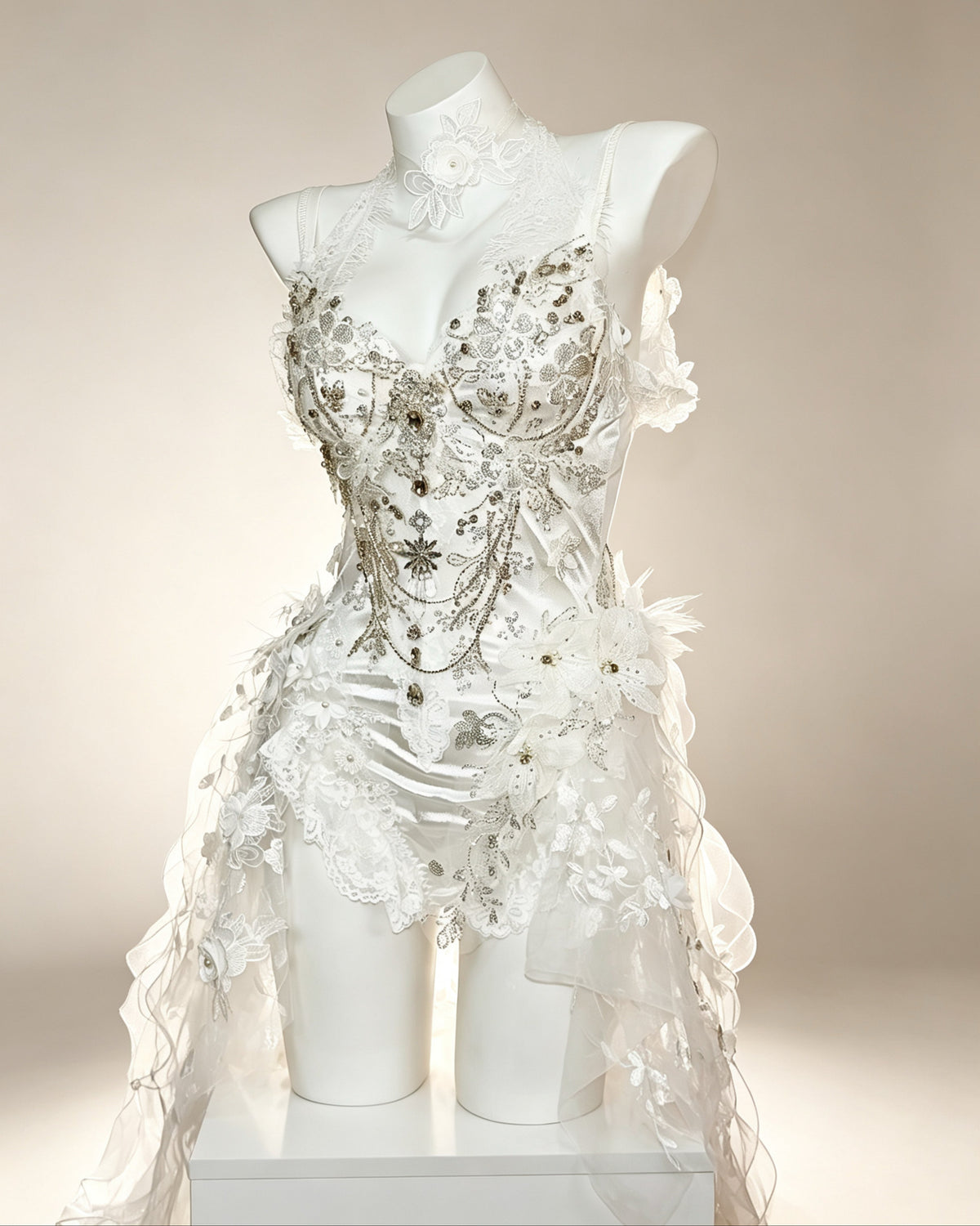Vesper ivory embellished bodysuit with floral appliqué, lace draping and crystal details – three-quarter view | AVRY
